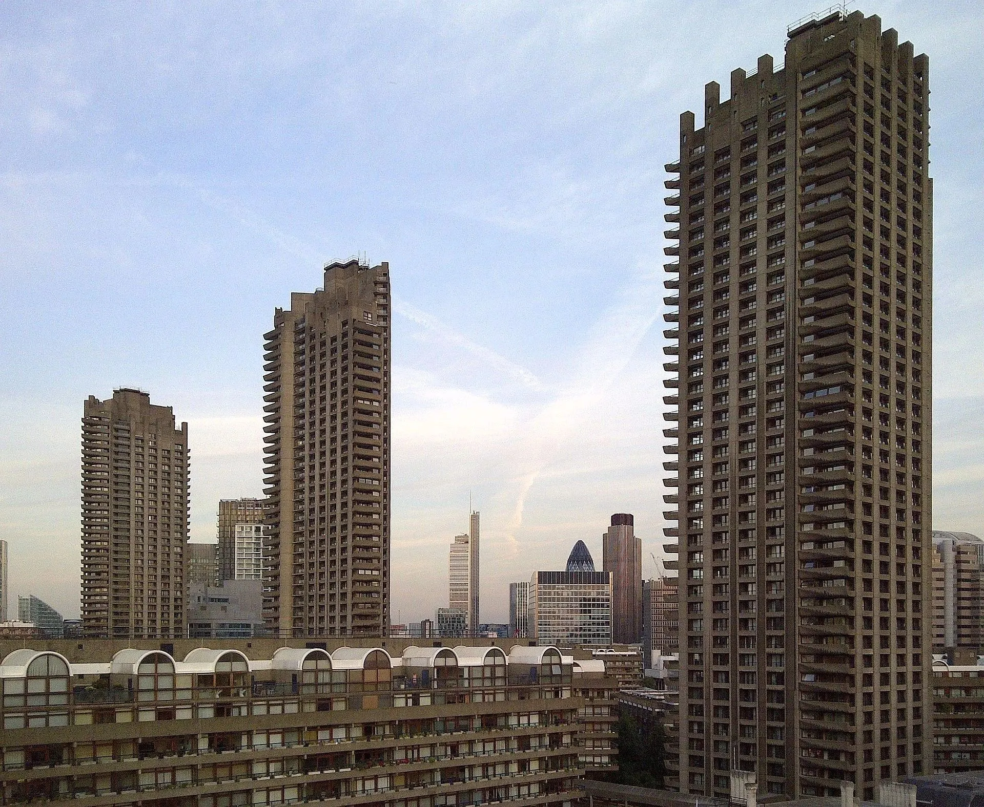 Barbican Estate tower blocks in London against a blue sky