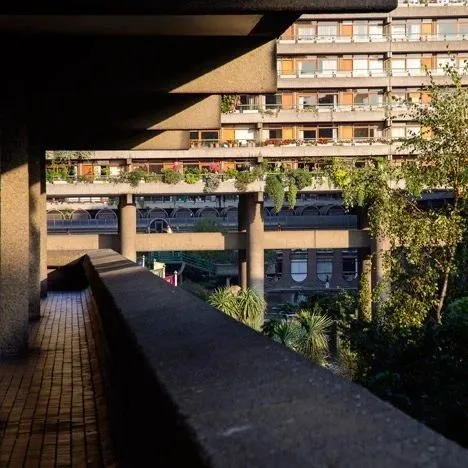 Concrete walkway and balconies of the Barbican Estate with greenery