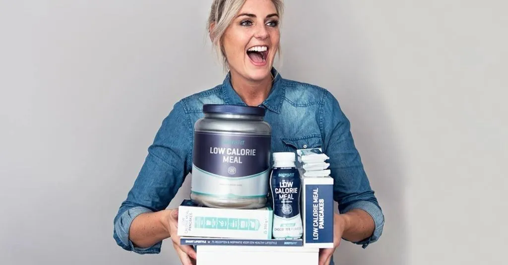 Smiling woman holding Body & Fit products