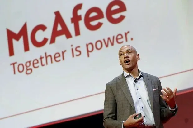 Speaker on stage in front of a McAfee "Together is power." backdrop